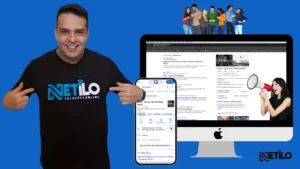 Imagem da agência de marketing Netilo destacando serviços de marketing digital. Homem sorridente veste camiseta com o logo da Netilo, ao lado de um iPhone exibindo o perfil do Google My Business da agência e um computador mostrando resultados de busca da Netilo no Google. Ao fundo, grupo de jovens interage com smartphones e mulher com megafone simboliza comunicação. Agência especializada em otimização de presença digital, local SEO, e Google Ads para negócios locais.